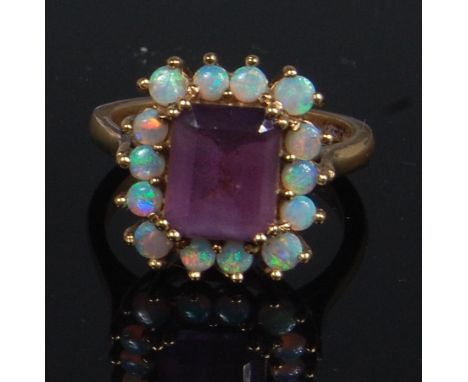 A ladies 9ct gold amethyst and opal cluster ring, the baguette cut amethyst in a surround of fourteen small opals, size Q-