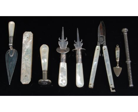 An early 20th century silver and mother of pearl handled bookmark, in the form of a trowel; together with a ladies mother of 