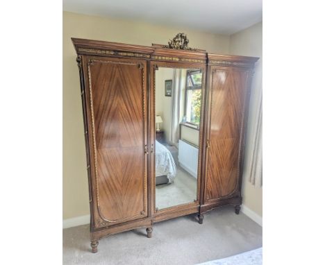 A large good quality French Empire style mahogany triple door fitted wardrobe, with gilt mounts. Early/Mid 20th Century.