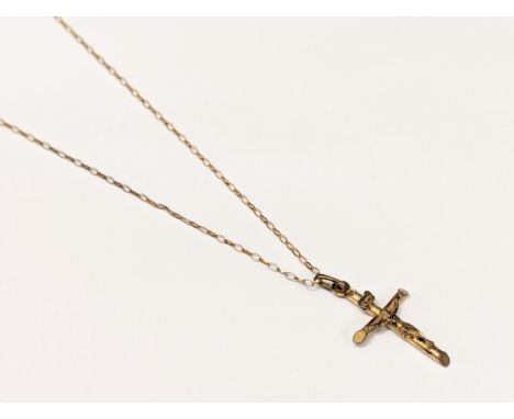 A 9ct gold crucifix pendant on chain. Total weight 1.75g