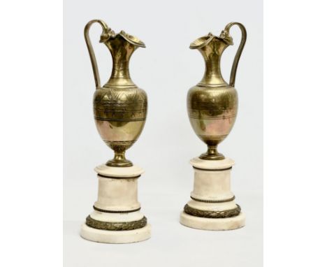 A pair of large Late 19th Century French engraved brass ewer style side garnitures on marble bases. 42cm