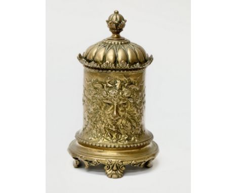 A 19th Century Victorian brass double sided tobacco jar/tea caddy, with 2 Green Man masks and flower foliage raised on scroll