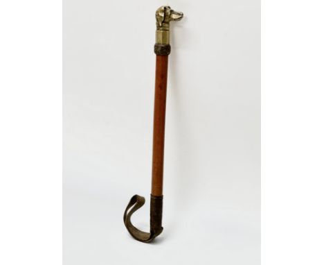 A Late 19th Century horse riding crop with brass mounted dog. 46cm