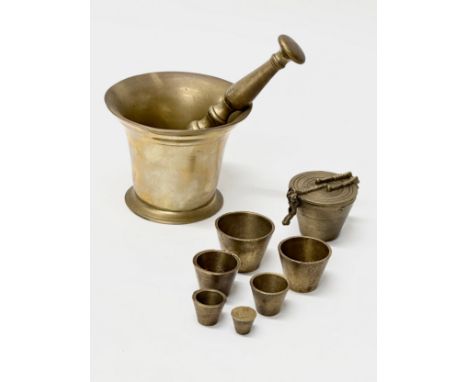 19th Century brass nesting weights and a mortar &amp; pestle.