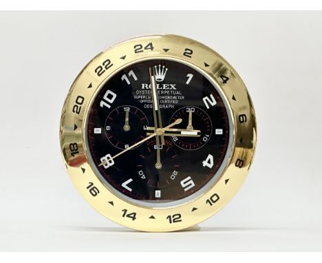 A Rolex Oyster Perpetual Daytona wall clock. 34cm