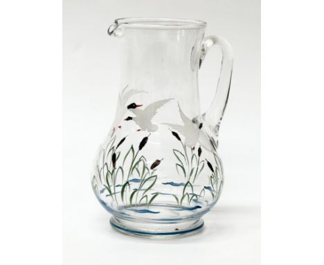 A Mid 20th Century glass pitcher with painted enamel flying ducks. 23cm