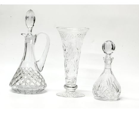Three pieces of crystal. A Stuart Crystal “Imperial” trumpet vase 22.5cm. A diamond cut claret jug 29cm. A small fan cut deca
