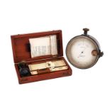A LATE VICTORIAN OXIDISED BRASS ANEROID SURVEYOR’S BAROMETER