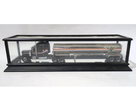 A Franklin Mint Peterbilt American Eagle tractor unit and tanker, in glass case measuring approx. 72cm long x 18cm high x 21c