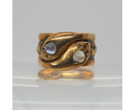 A 9ct rose gold double snake ring, the heads set with cabochon moonstones, hallmarked Birmingham 1863, size V1/2, weight 7.5g