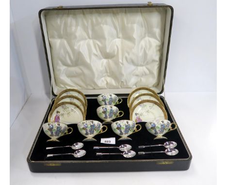 Boxed Noritake coffee cups and saucers, each decorated with a geisha, together with six silver spoons by Duncan and Scobbie, 