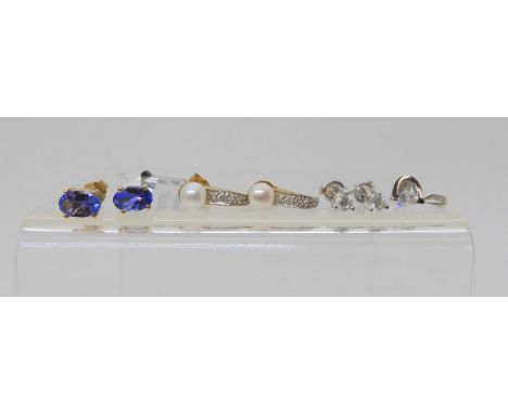 An 18k gold diamond pendant set with an estimated approx 0.20ct diamond, with a pair of similar diamond stud earrings set wit