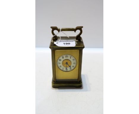 A French brass and glass carriage clock with enamel chapter ring with arabic numerals Condition Report:Available upon request