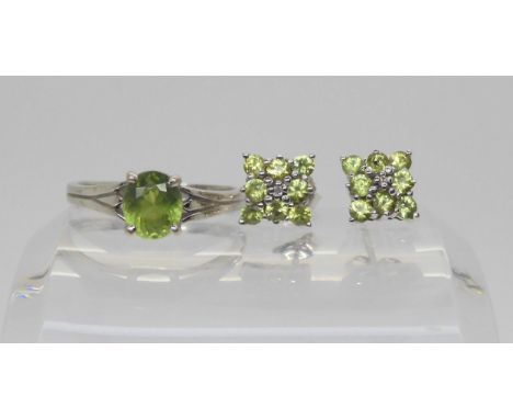 An 18ct white gold demantoid garnet ring size P1/2, weight 3.7gms, together with a pair of 9ct white gold demantoid garnet cl