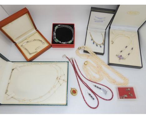 A collection of silver and costume jewellery to include ruby beads, sapphire and white zircon earrings etc Condition Report:A