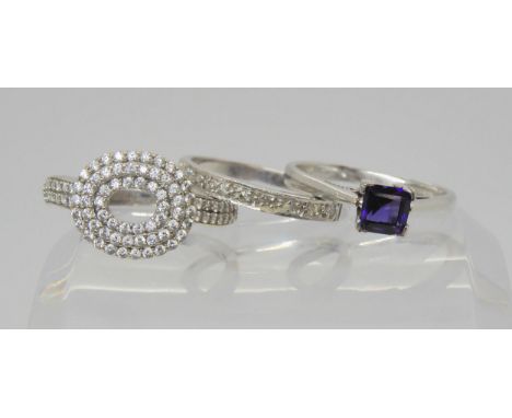 An 18ct white gold amethyst ring, size L1/2, weight 2.7gms, and two 9ct white gold rings, a cz cluster , size P1/2, and a dia