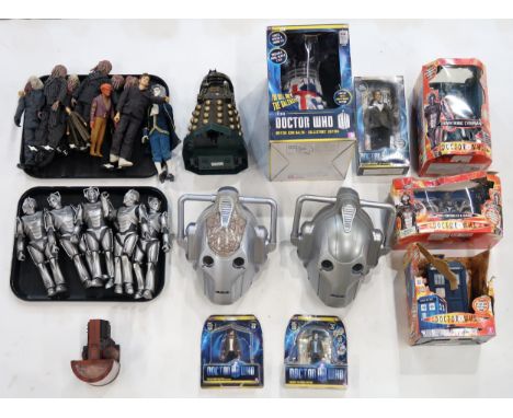A collection of Doctor Who action figures, including David Tennant as the Doctor, battery-operated Daleks and Cyberman, two C