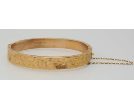 A 9ct gold bangle with foliate engraving, weight 10.9gms Condition Report:Available upon request