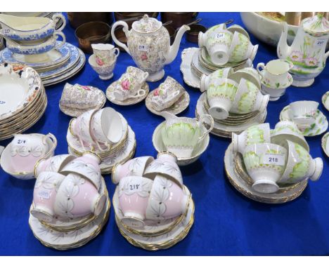 A Tuscan green flower decorated tea set comprising twelve cups, saucers, plates, cake plate, milk jug and sugar bowl, a Rosly