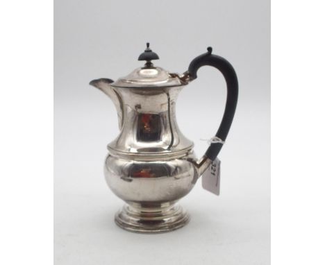 A George VI silver hot water pot, of baluster form, on a stepped circular base, with an ebonised handle and finial, by&nbsp;L