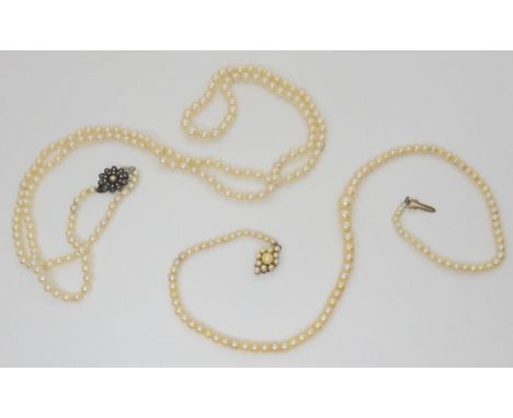Two strings of pearls, one is 41cm, with a 9ct gold pearl set clasp the other is 92cm, with a silver and marcasite flower cla