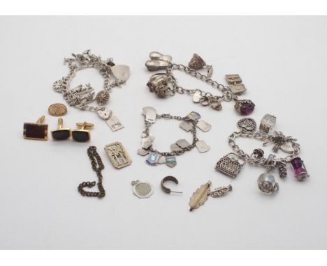 A collection of four silver and white metal charm bracelets, with various silver and white metal charms including keys, bells