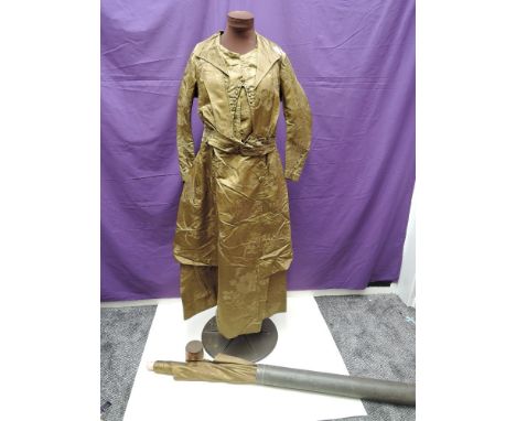 A late 19th century dress made for Rosetta Chadwick, constructed of moss green Chinese silk,having bracelet length sleeves wi