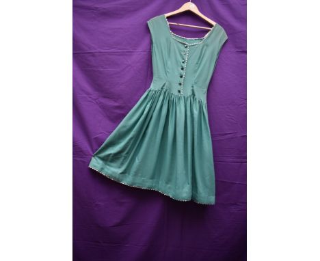 A 1950s green cotton full skirted day dress having ric rac edging, button front and slightly dropped waist.