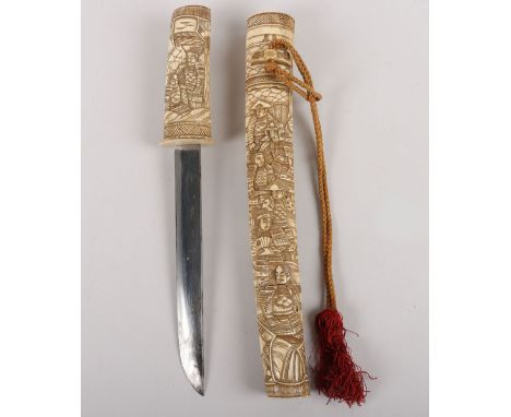 Japanese Carved Bone Dagger, blade 20cms (not tempered),hilt and scabbard carved overall with assorted retainers and samurai.