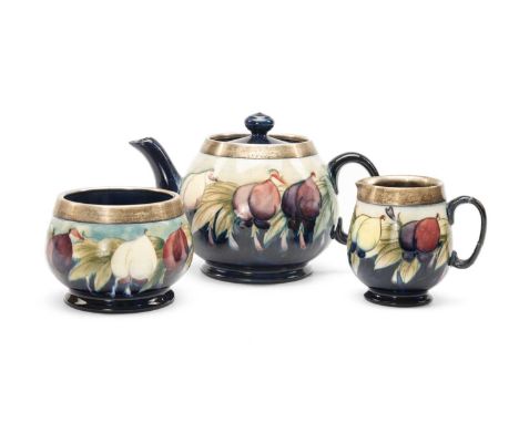 MOORCROFT SILVER MOUNTED 'WISTERIA' PATTERN TEASET, comprising teapot, milk jug and sugar basin, on a graduated light and dar