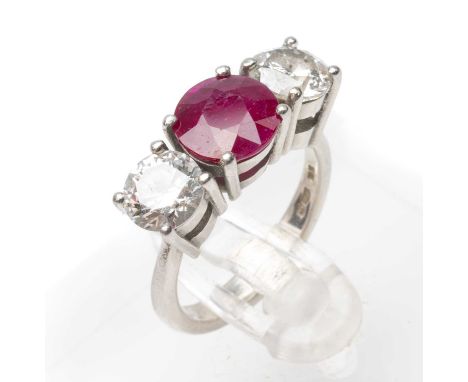 PLATINUM THREE STONE DIAMOND & RUBY RING, the central round cut ruby (8mm diameter approx.) flanked by two diamonds measuring