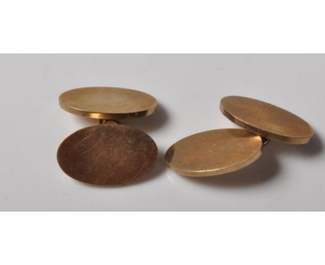 A pair of vintage hallmarked 9ct gold cufflinks having oval heads united by chains. Hallmarked Birmingham 1969. Weight 14.1g.