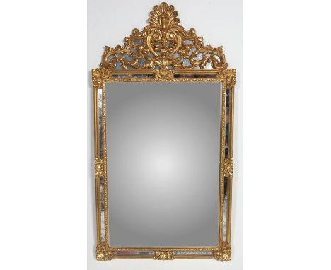 An antique revival contemporary Venetian antique style wall mirror having a central rectangular mirror glass panel set within