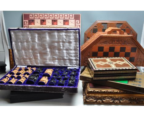 A large collection of vintage 20th century chess pieces and chess boards to include vast variety of carved pieces, and hand c