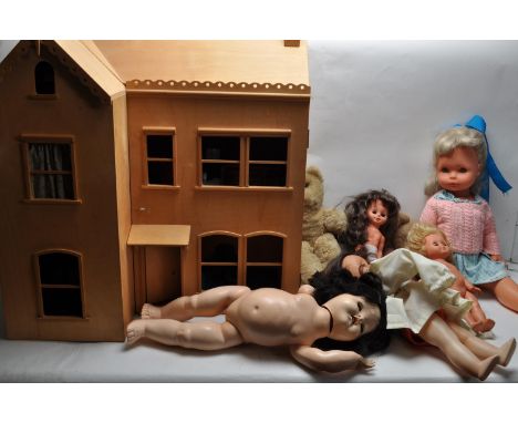 A large vintage 20th century wooden dolls house having hinged front opening to reveal a compartmented interior complete with 