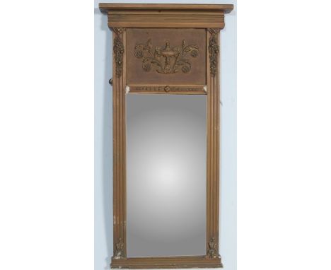 An antique style pier mirror having gilt moulded decoration with a rectangular bevelled glass mirror with urn and scrolled fo