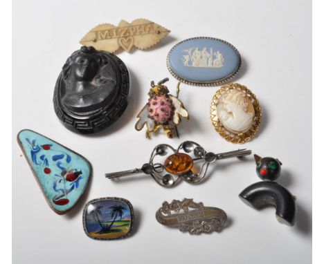 A collection of 19th Century Victorian and later brooches to include a Victorian jet brooch, an Art Deco style enamel brooch,