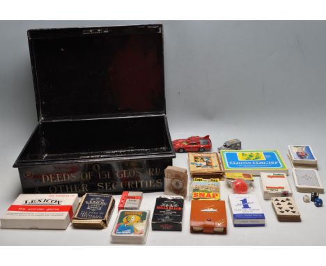 A 20th century black metal deeds box and collection of vintage 20th century children's parlour games and playing cards. The b