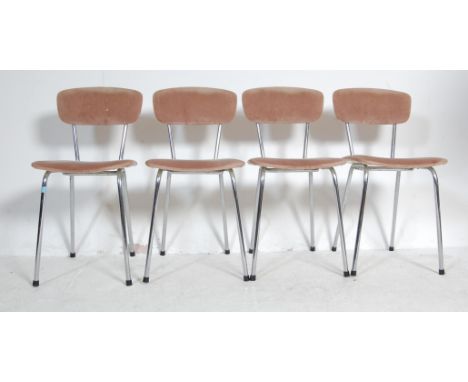 A set of four vintage 1950's American Diner inspired dining chairs having padded backrests and seats being raised on chrome t