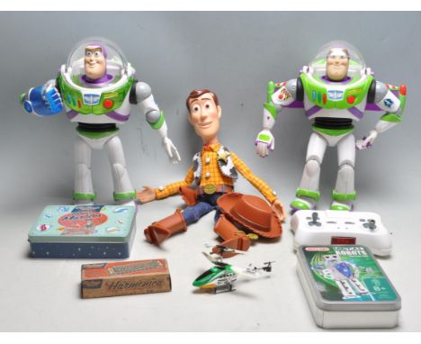 A collection of vintage 20th century toys figurines and games to include Woody from toy story, two Buzz lightyear with variou