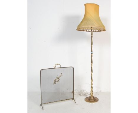 A mid century antique style brass floor standard lamp having multi section turned column being raised on a circular base alon