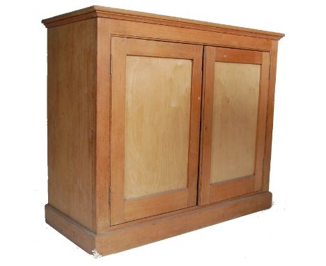 A Victorian 19th century pine School cupboard of upright form complete with a plinth base and two full length panel doors hou