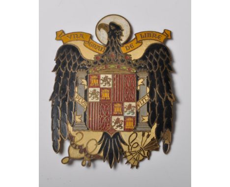 Of motoring interest - An early 20th Century Spanish enamel car badge, in the form of a black and gold eagle set with coat of