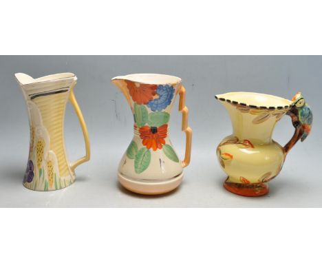 A collection of three 1930s Early 20th Century Art Deco ceramic jugs comprising of two Wadeheath jugs having a yellow backgro