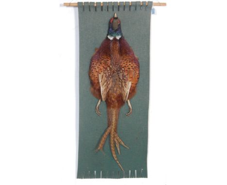 A vintage late 20th century taxidermy wall hanging of a pheasant. The wall hanging has pheasants feathers to the centre,&nbsp