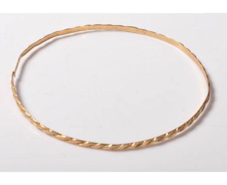 A high carat likely continental gold arm bangle / bracelet&nbsp; having a raised rope twist design to the exterior. Indistinc