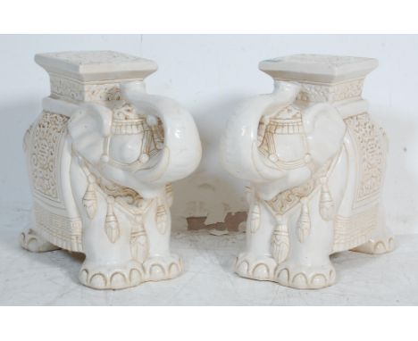 A pair of 20th century large Chinese ceramic planter / stool in the form of an Elephant having painted white glazed decoratio