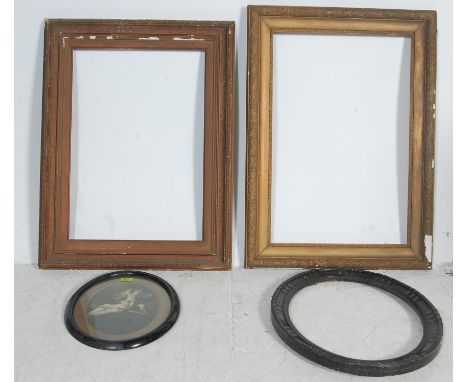 A collection of four vintage 20th century picture frames comprising of 2 gilt plaster square frames and two oval ebonised fra