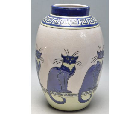 A late 20th century Lonwys style ceramic vase having a blue and yellow greek key decoration to the top with a repeating styli