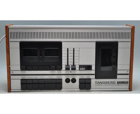 A vintage retro 20th century TANDBERG TCD 310 three motors - dual capstan cassettes player having brushed aluminium front, bl